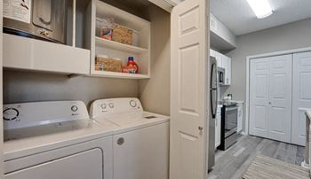 Laundry room with washer dryer and cabinetry